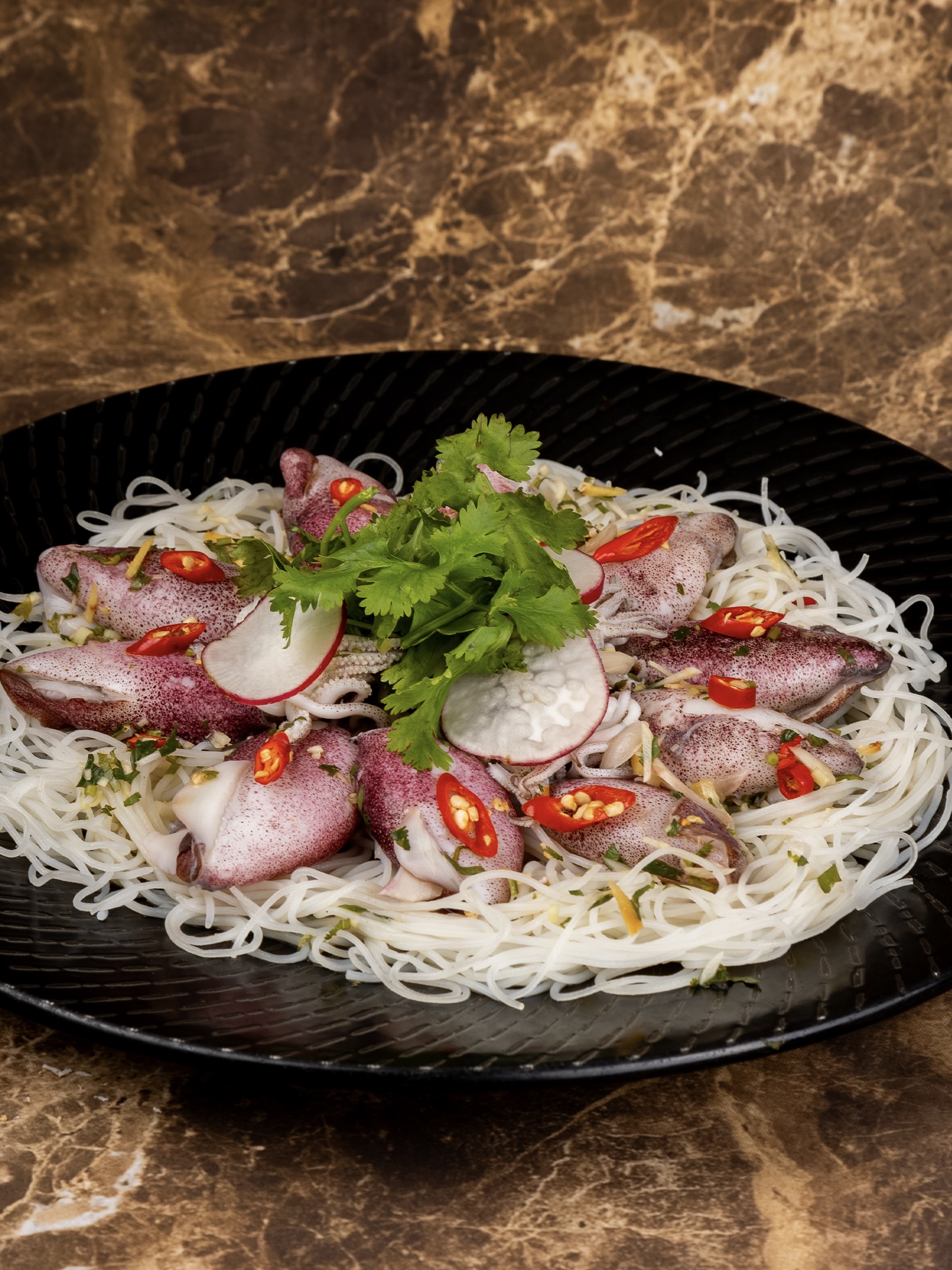 Pla Muek Neung Manao at Silk Road, Newport World Resorts Well into the Lenten season, Silk Road at Newport Grand Wing adds one of the most popular Thai dishes to its international menu come March. The Pla Muek Neung Manao features steamed squid infused with fragrant lime chili garlic sauce. For PHP 680 nett, the Steamed Squid in Thai Style is served with rice vermicelli great for sharing between 2-3 persons.