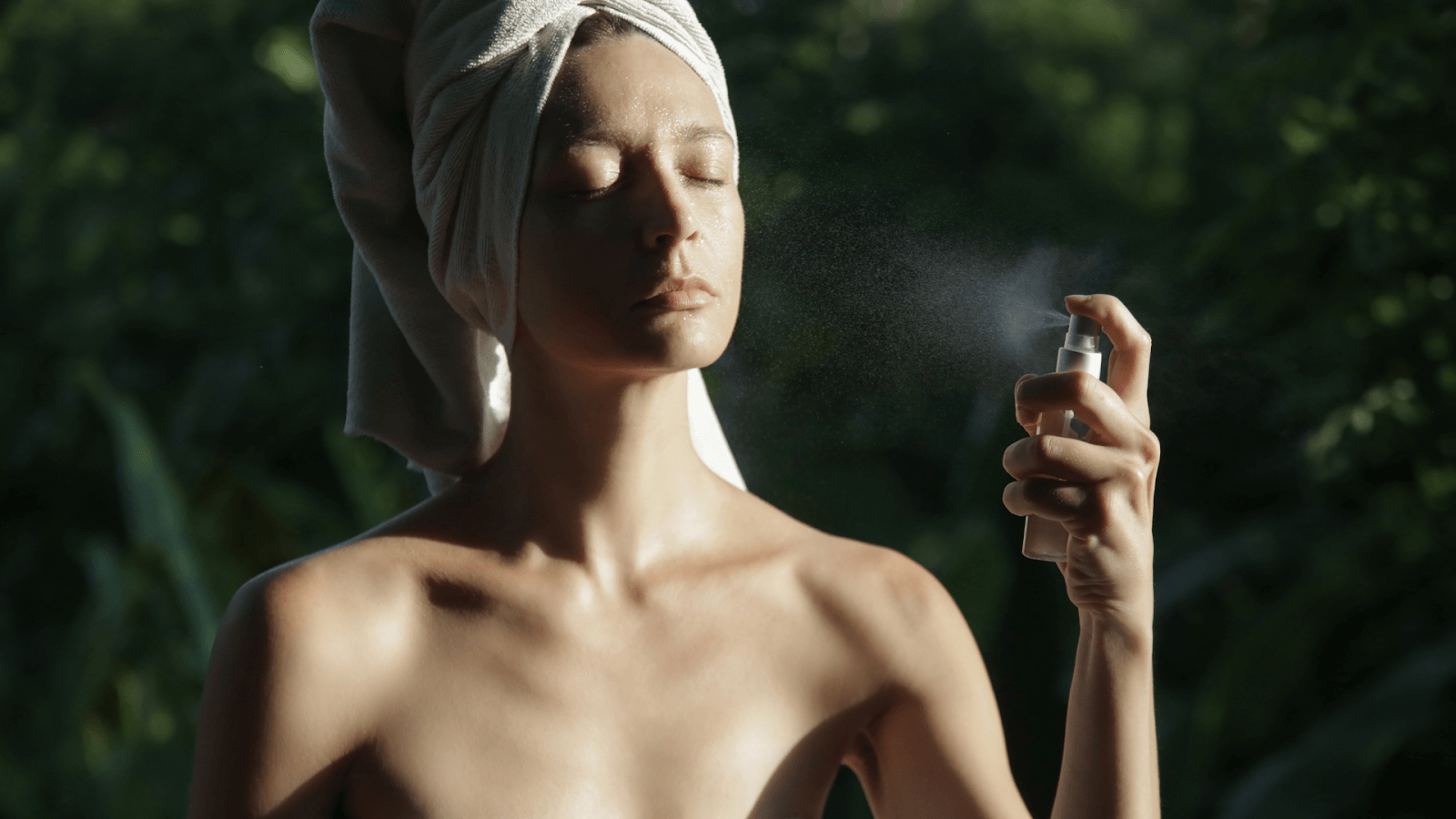 Girl spraying perfume to her body