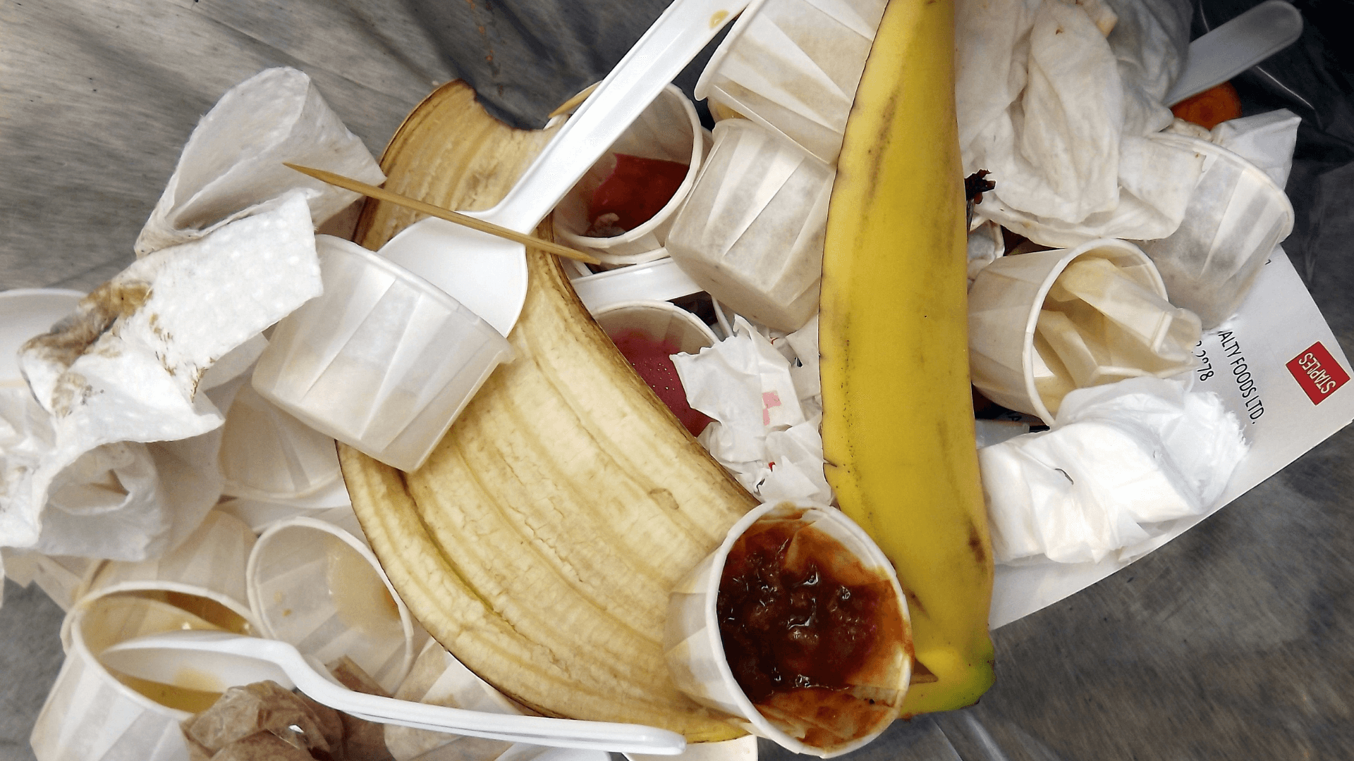 used disposable cups and spoon, stick, banana peel