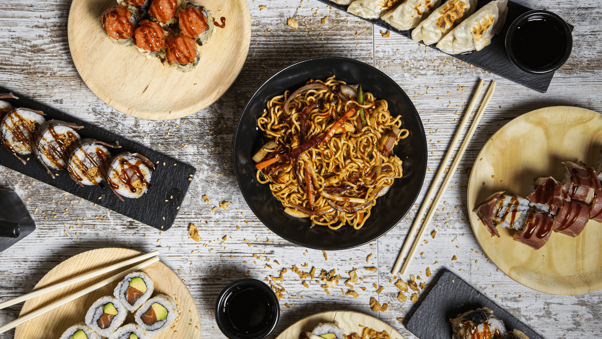 Different Japanese food including noodles, meat, sushi, and gyoza