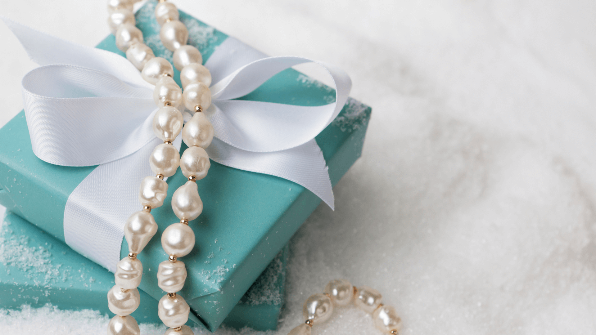 Pearl necklace on top of a gift box